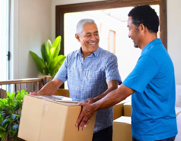 Photo of a son helping his father move